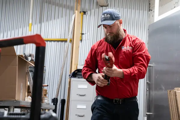 Mr. Rooter professional on the way to clean a blocked drain.