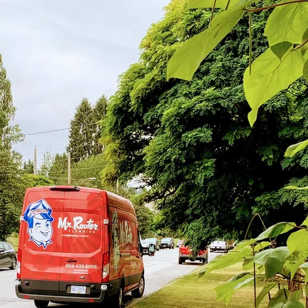 Mr. Rooter Plumbing van parked outside of New Westminster home