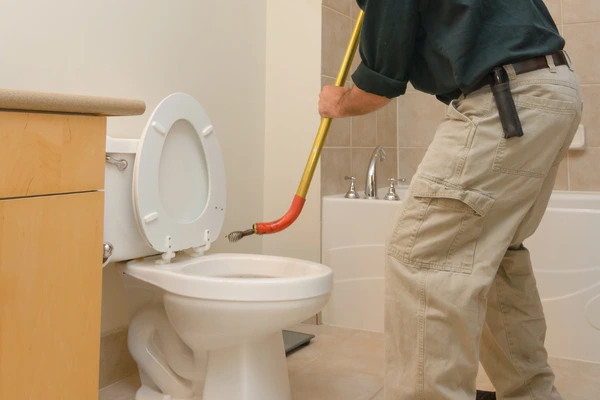 Image of using a Toilet Auger.