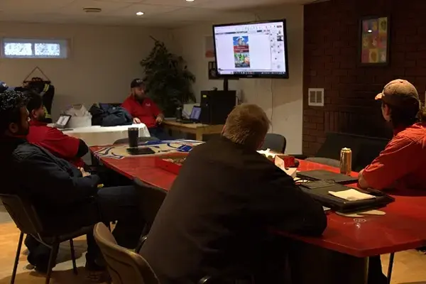 Mr. Rooter employees sitting at a table.