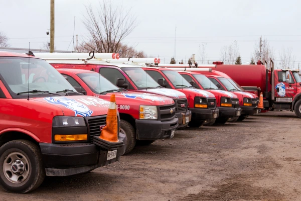 Photo of several Mr. Rooter vans parked in a row.