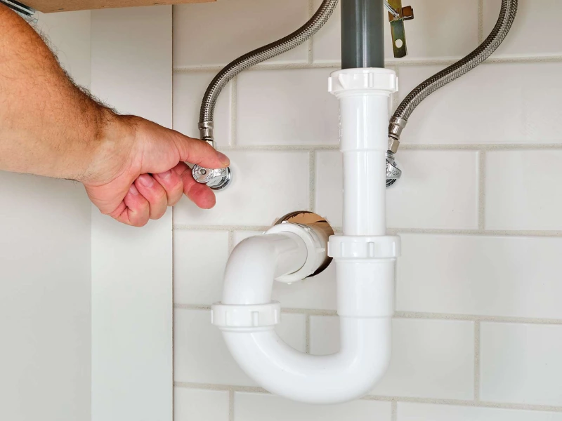 Mr. Rooter professional shutting off a water valve.