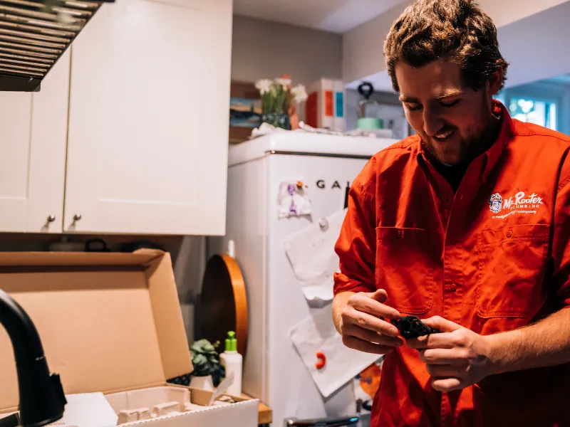 Mr. Rooter professional in a kitchen.