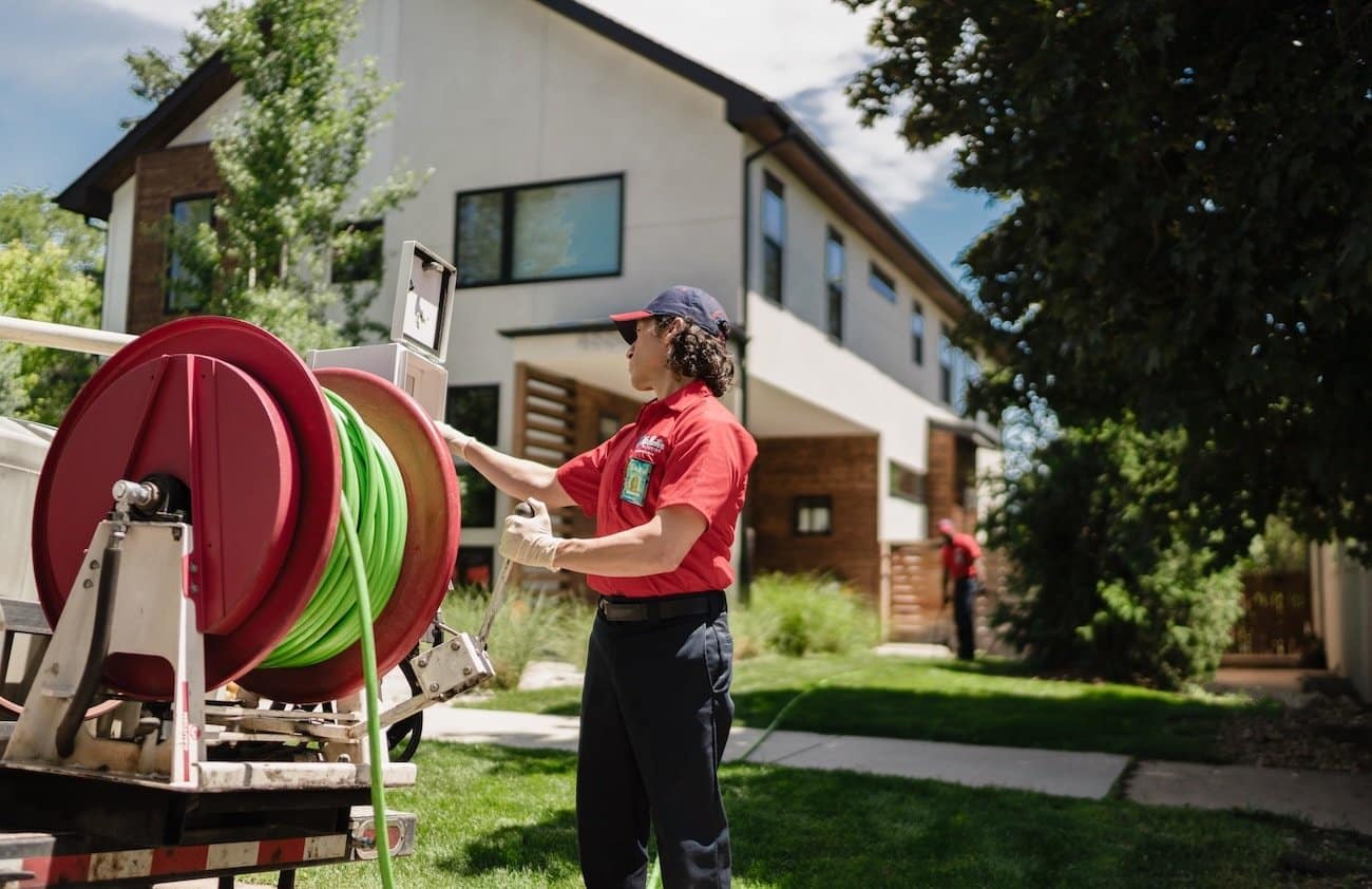 A Mr. Rooter proffesional preparing equipment to service a clogged pipe
